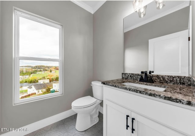 bathroom featuring crown molding, vanity, and toilet