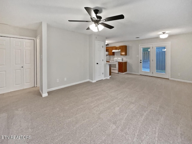 unfurnished living room with light carpet and ceiling fan