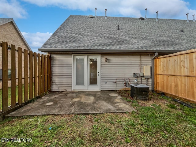 rear view of property with cooling unit and a patio area