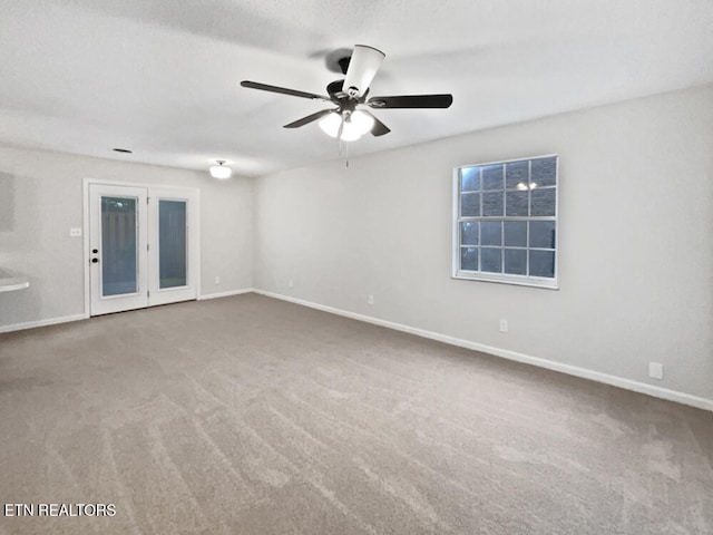 empty room with carpet flooring and ceiling fan