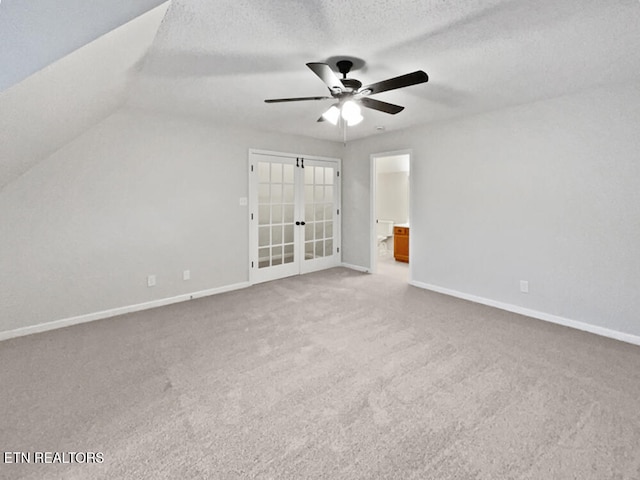 interior space featuring carpet flooring, ceiling fan, a textured ceiling, and vaulted ceiling