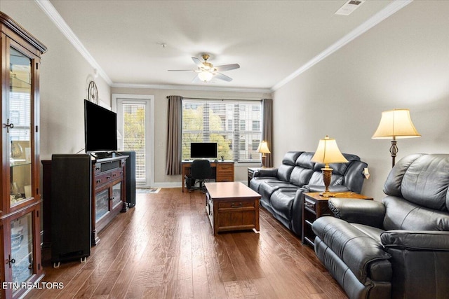 living room featuring dark hardwood / wood-style floors, ceiling fan, and ornamental molding