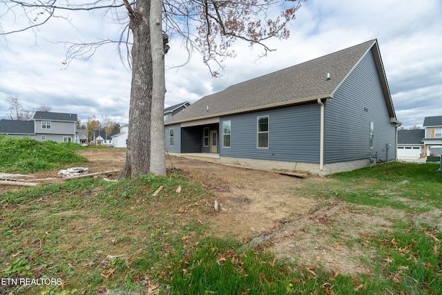 back of house with a yard