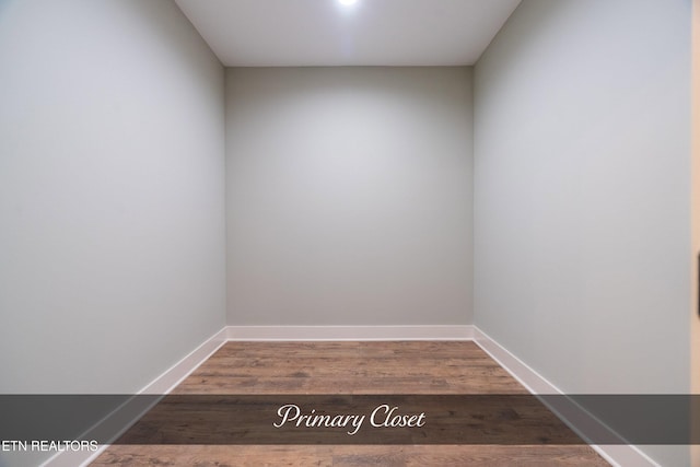 empty room with dark hardwood / wood-style flooring