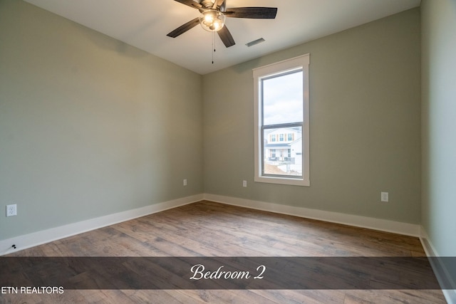 empty room featuring hardwood / wood-style floors and ceiling fan