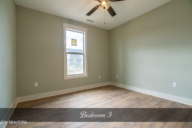 empty room with light hardwood / wood-style flooring, plenty of natural light, and ceiling fan