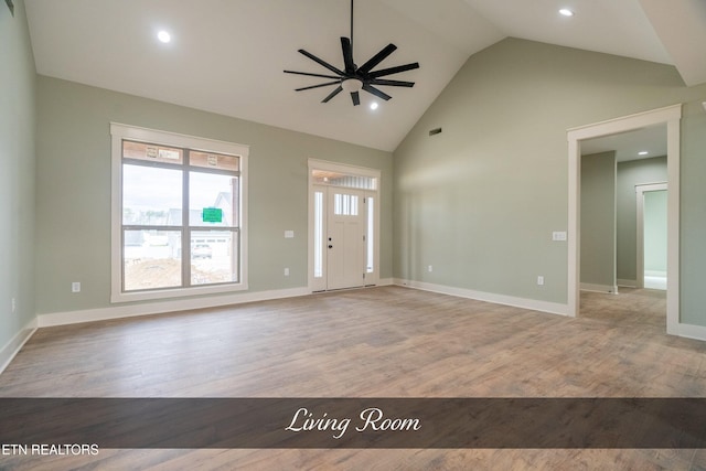 unfurnished living room featuring ceiling fan, high vaulted ceiling, and light hardwood / wood-style floors