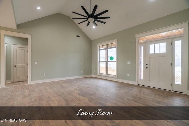 entryway featuring ceiling fan, light wood-type flooring, and high vaulted ceiling