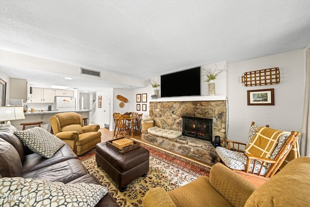 living room featuring a fireplace and a textured ceiling