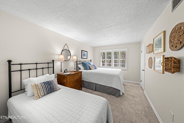 carpeted bedroom featuring a textured ceiling