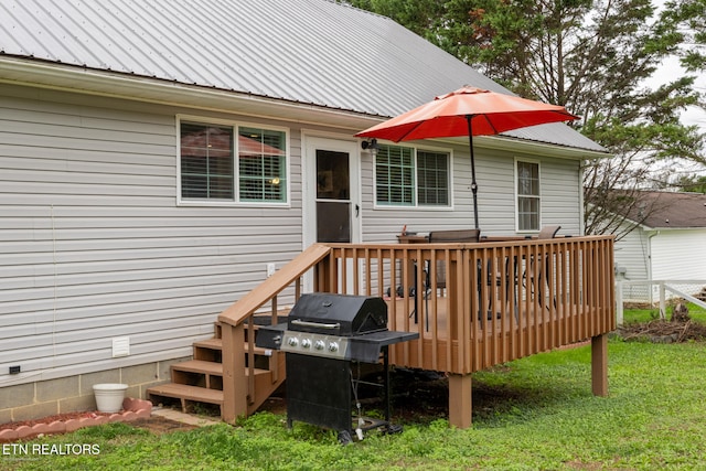 wooden deck featuring a lawn and grilling area