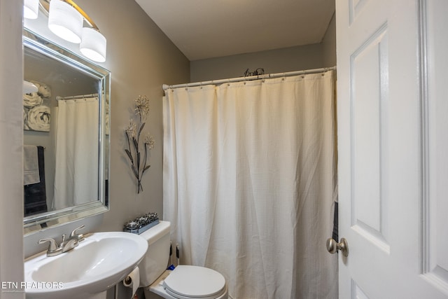 bathroom featuring toilet and sink