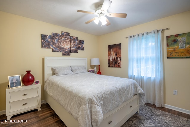 bedroom with dark hardwood / wood-style floors and ceiling fan