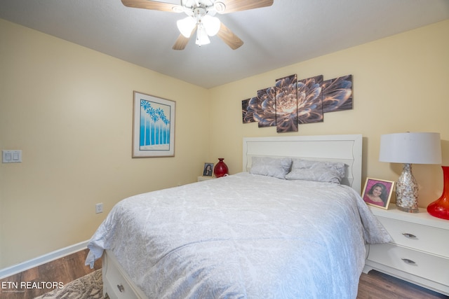 bedroom with ceiling fan and dark hardwood / wood-style flooring