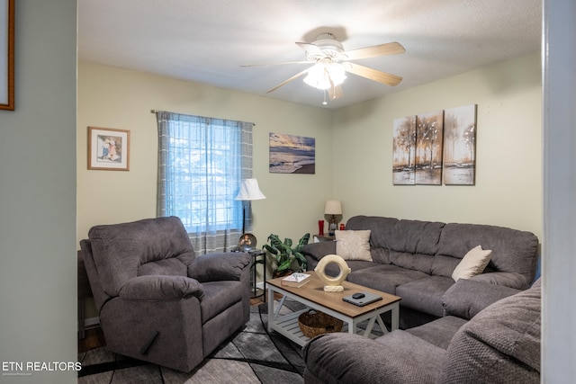 living room featuring a textured ceiling and ceiling fan