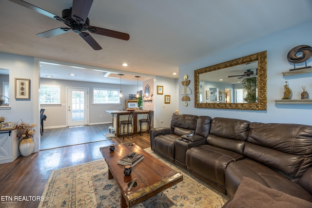 living room featuring dark hardwood / wood-style floors and ceiling fan