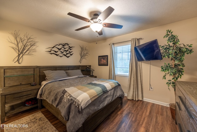 bedroom with a textured ceiling, dark hardwood / wood-style flooring, and ceiling fan