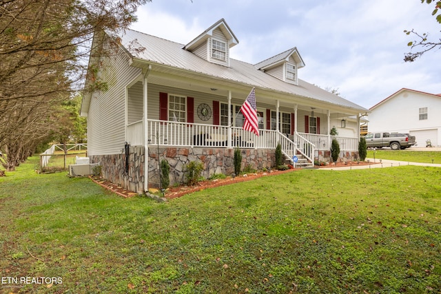 cape cod-style house with a front lawn and covered porch