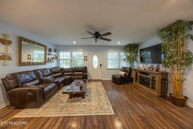 living room featuring dark hardwood / wood-style flooring and ceiling fan