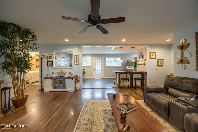 living room with dark hardwood / wood-style floors and ceiling fan