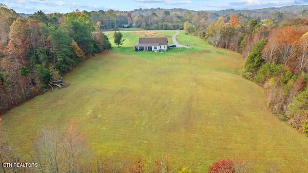 birds eye view of property with a rural view