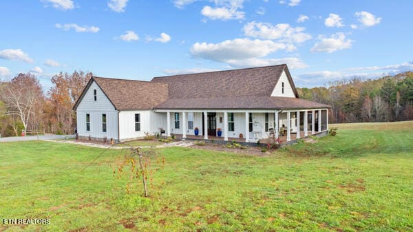 view of front of property with covered porch and a front yard