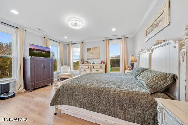 bedroom featuring light hardwood / wood-style floors and ornamental molding