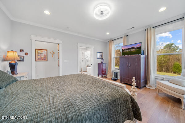 bedroom with wood-type flooring and ornamental molding