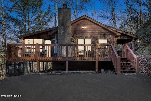 back of house featuring a deck