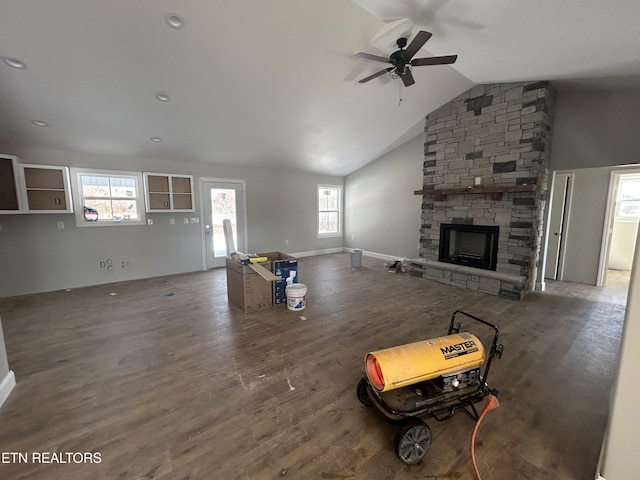 unfurnished living room with vaulted ceiling, ceiling fan, a fireplace, and dark hardwood / wood-style flooring