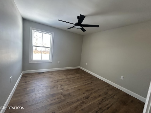 unfurnished room featuring dark hardwood / wood-style floors and ceiling fan