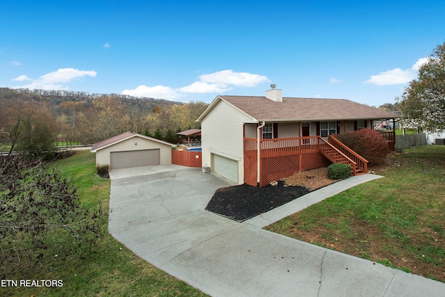 ranch-style house with a garage, covered porch, an outdoor structure, and a front lawn