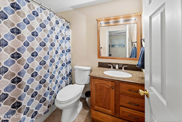 bathroom with tile patterned floors, vanity, and toilet