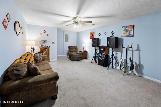 living room featuring ceiling fan, light colored carpet, and a textured ceiling