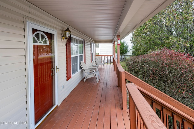 wooden terrace featuring covered porch