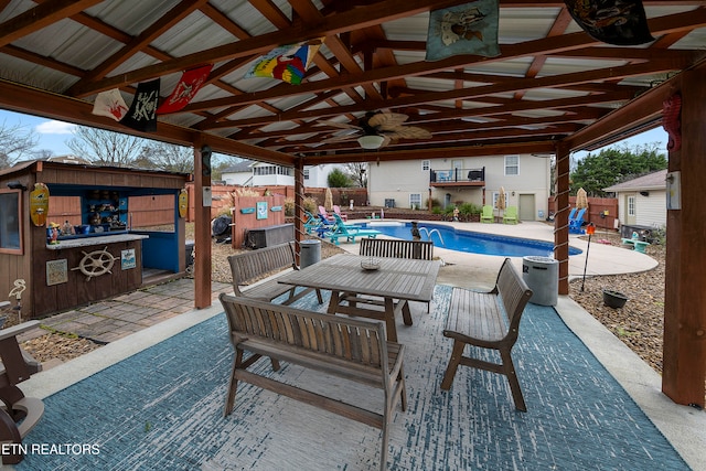 view of patio / terrace featuring ceiling fan and a fenced in pool