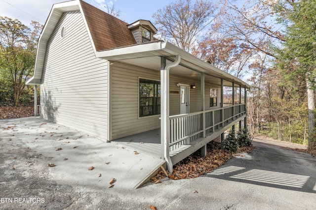 view of side of home featuring a porch