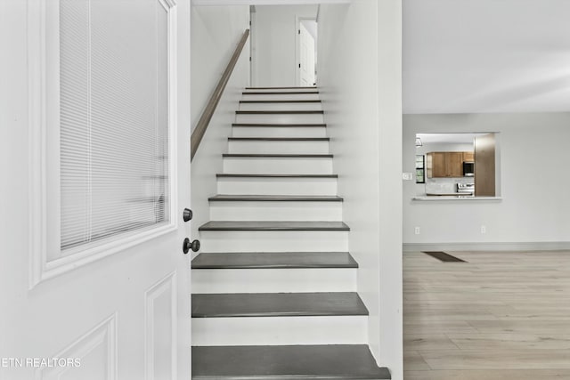 stairway featuring hardwood / wood-style flooring