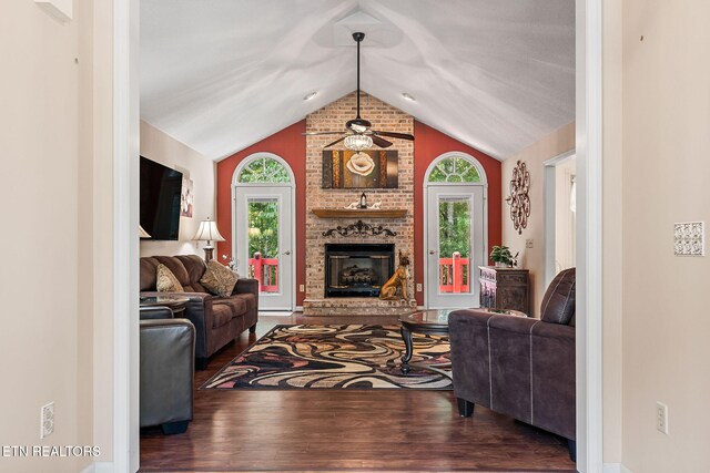 living room with ceiling fan, a healthy amount of sunlight, wood-type flooring, and a fireplace