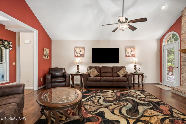 living room featuring ceiling fan, wood-type flooring, and lofted ceiling