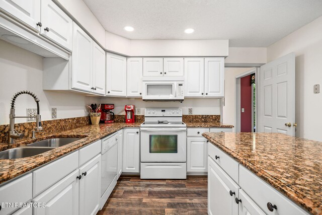 kitchen featuring sink, white cabinets, dark hardwood / wood-style floors, and white appliances