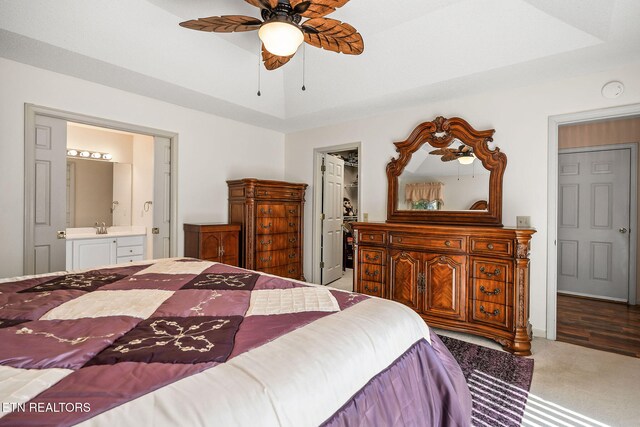 bedroom featuring carpet flooring, ensuite bathroom, and ceiling fan