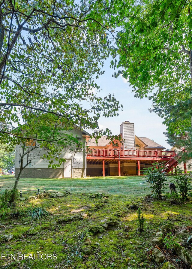 view of yard featuring a wooden deck