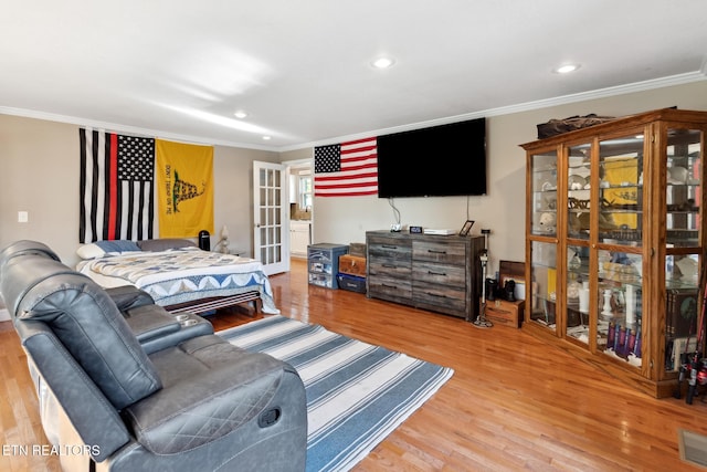 bedroom featuring crown molding and hardwood / wood-style floors