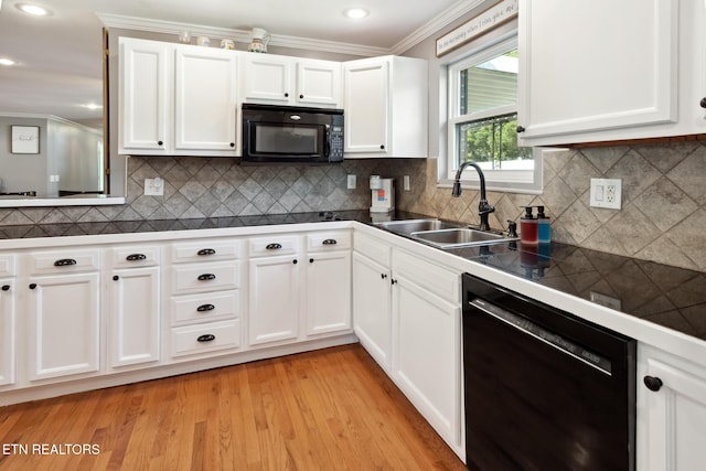 kitchen featuring white cabinets, light wood-type flooring, sink, and black appliances