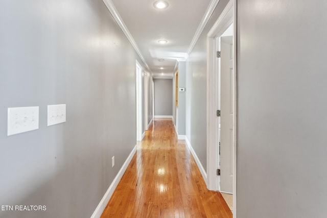 corridor featuring crown molding and light hardwood / wood-style floors