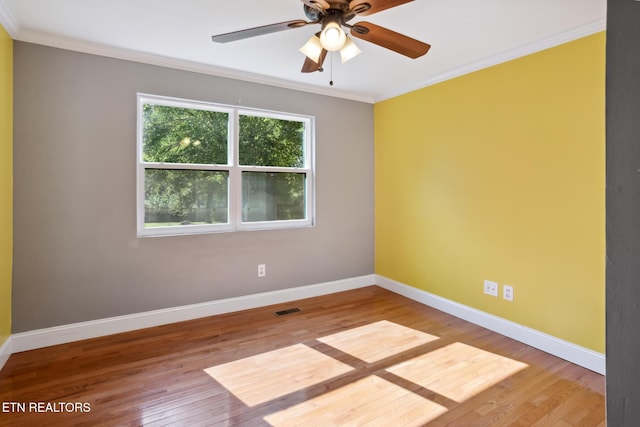 empty room featuring ceiling fan, light wood-type flooring, and crown molding