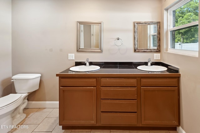 bathroom featuring tile patterned flooring, vanity, and toilet