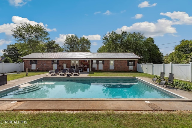 view of pool with a yard and a patio area