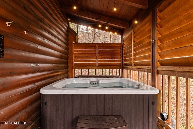 wooden deck featuring a hot tub